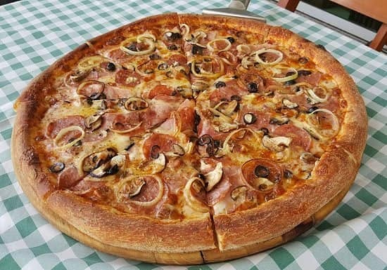 A large pizza on a checkered tablecloth